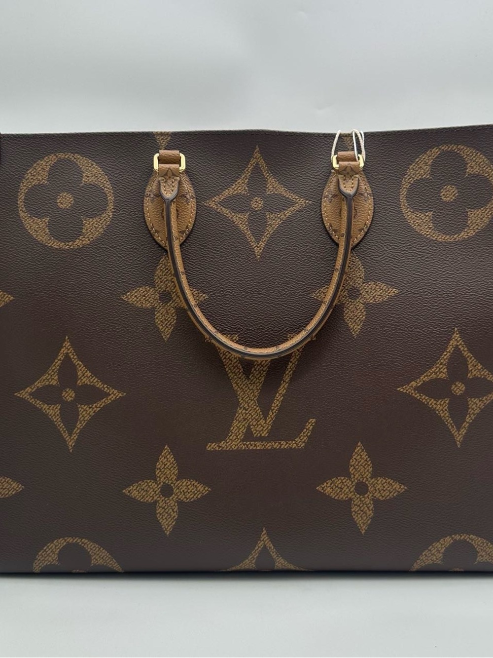 Louis Vuitton On The Go GM in reverse monogram giant canvas with gold-tone metal